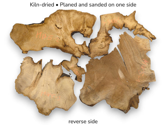 Kiln-dried, irregular raw wood slices with live edges and prominent grain, showing their reverse side.