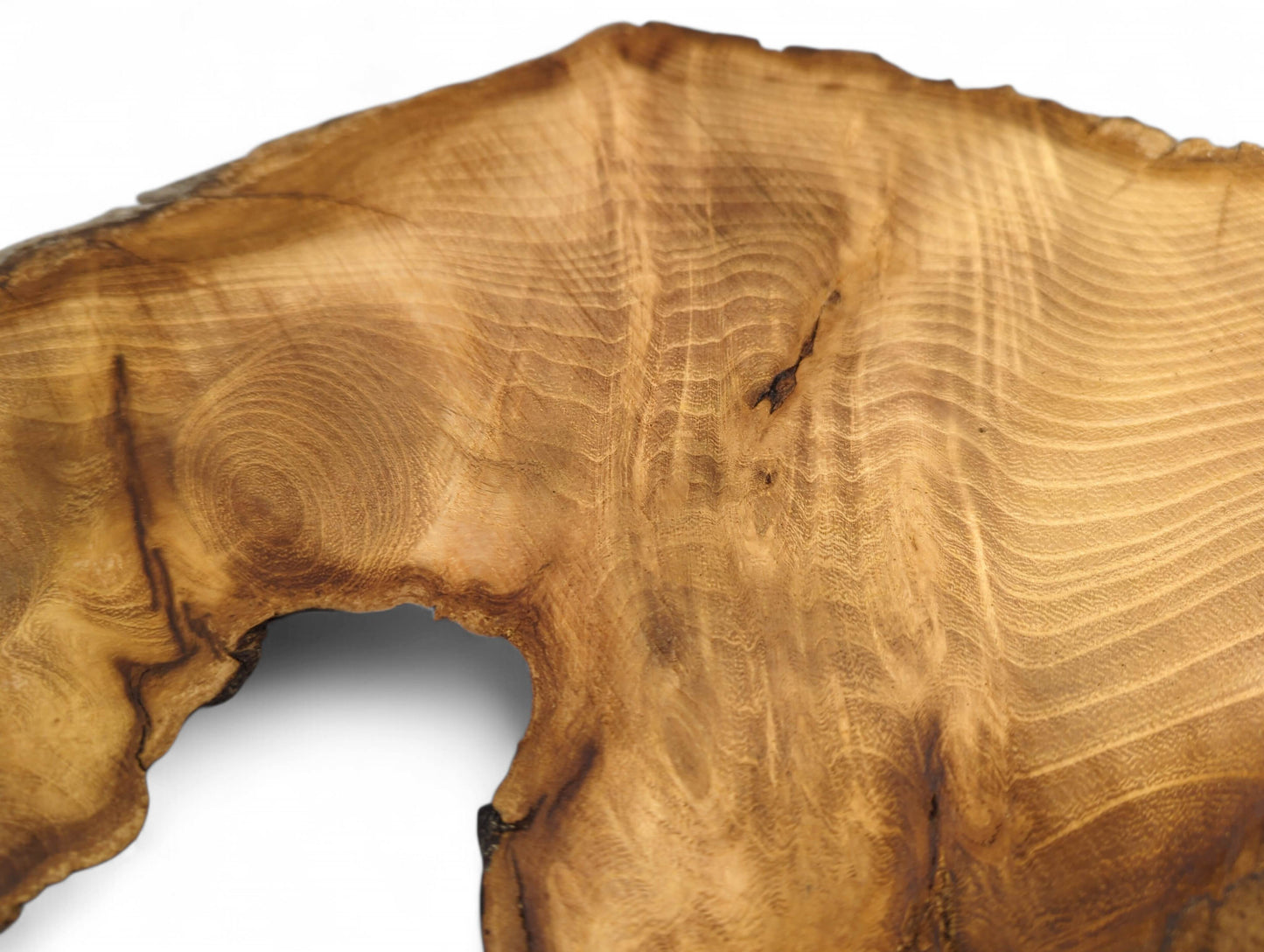 Irregular medium brown wood slice with prominent grain, dark live edge, and natural hole.