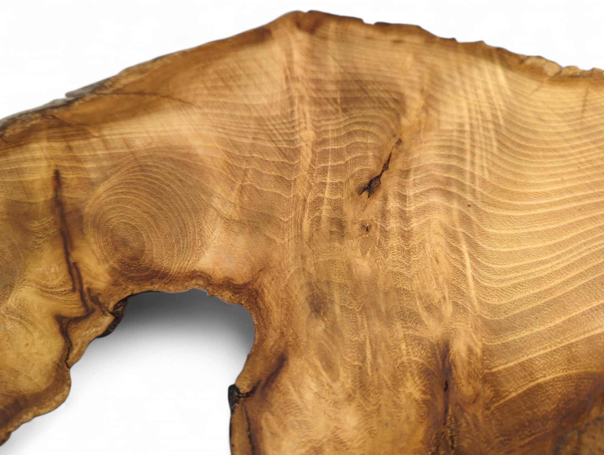 Irregular medium brown wood slice with prominent grain, dark live edge, and natural hole.
