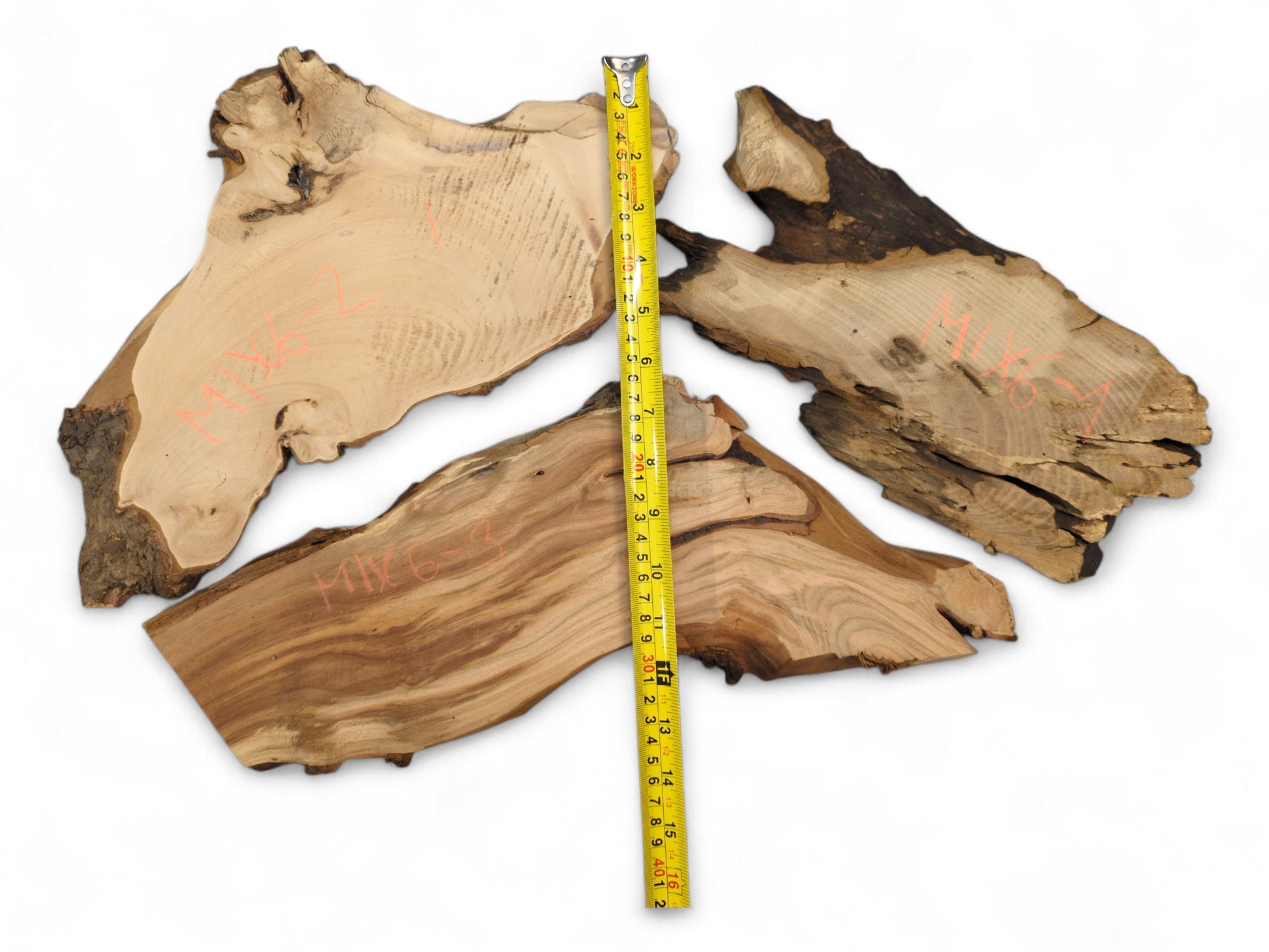 Three irregular live edge wood slices display varied brown tones, visible grain, red text, and a yellow measuring tape.