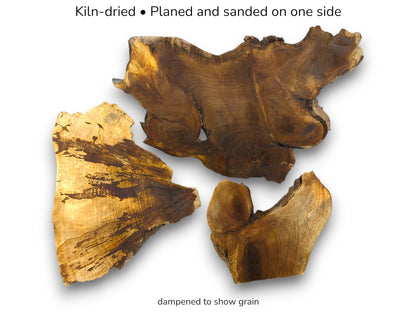 Three irregular hardwood slabs with live edges display rich, swirling grain in contrasting light tones.