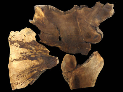 Natural live edge wood slices: one light brown, two dark brown, displaying distinct grain on black.