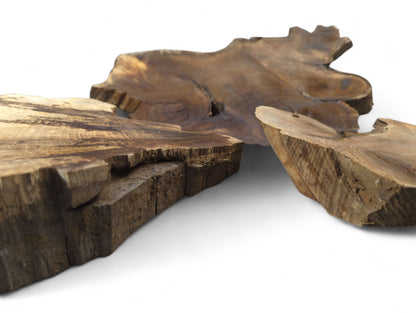 Three irregular brown wood slices, some wedge-shaped, showing natural live edges and grain.