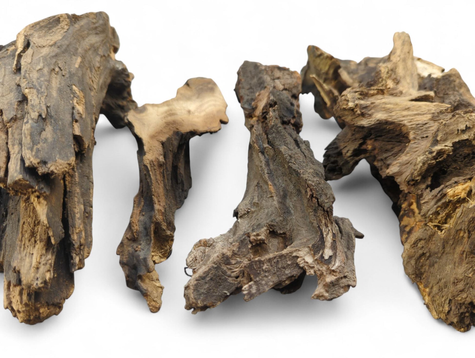 Four gnarled, irregular pieces of dark brown aged wood, featuring rough textures and lighter grain.