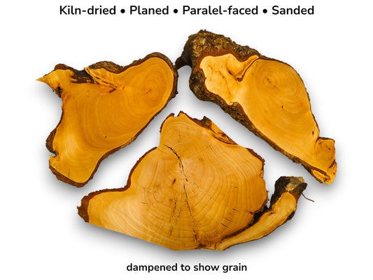 From above, three irregular timber sections reveal golden grain, a central crack, and coarse bark.
