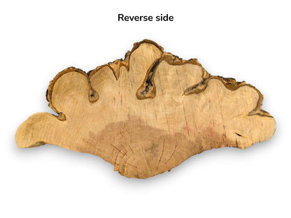 An irregular, light brown cherry endgrain wood cookie, with dark bark and text 'Reverse side'.