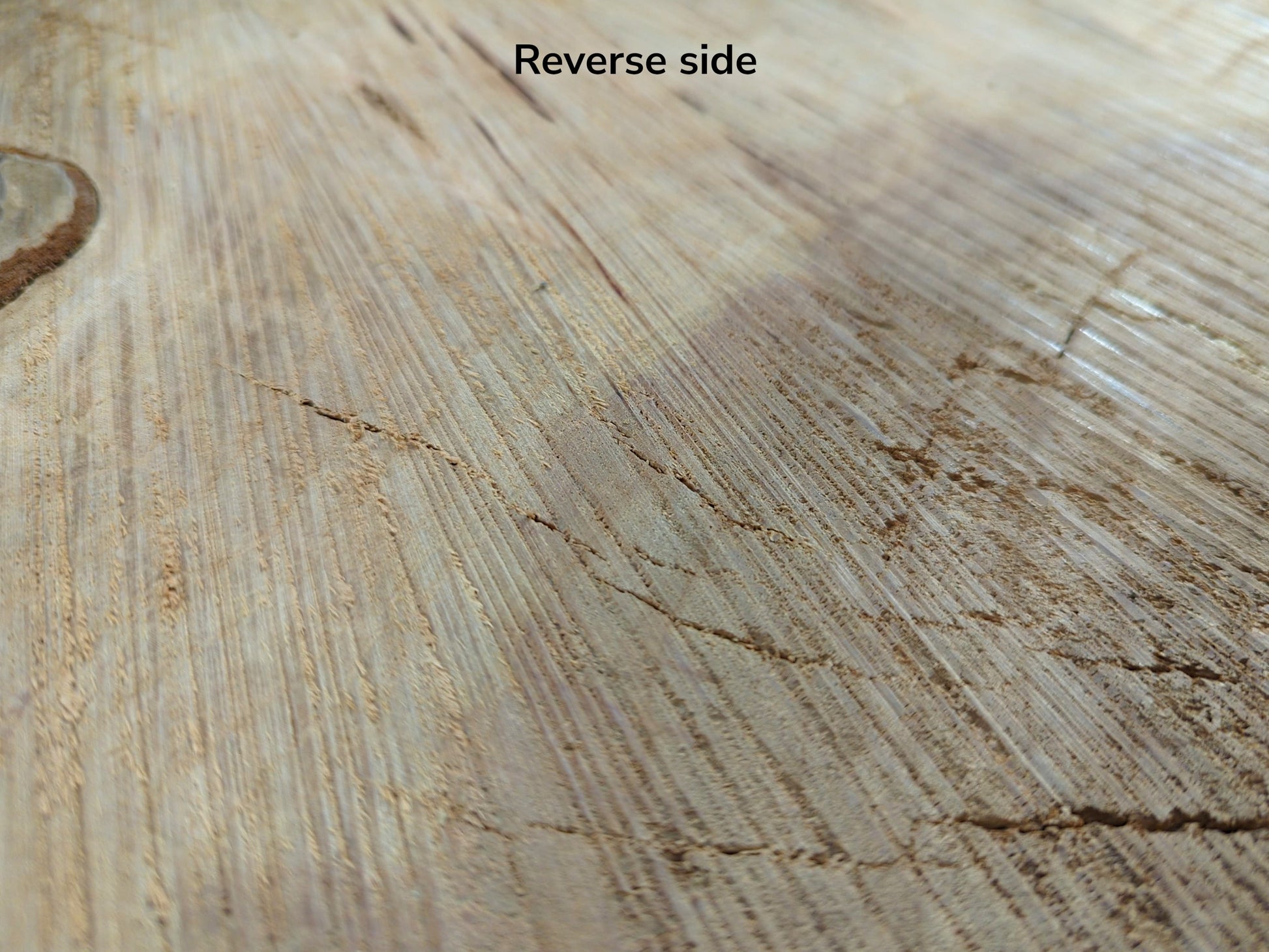 Image with 'Reverse side' text showing light brown cherry wood endgrain, featuring saw marks and cracks.