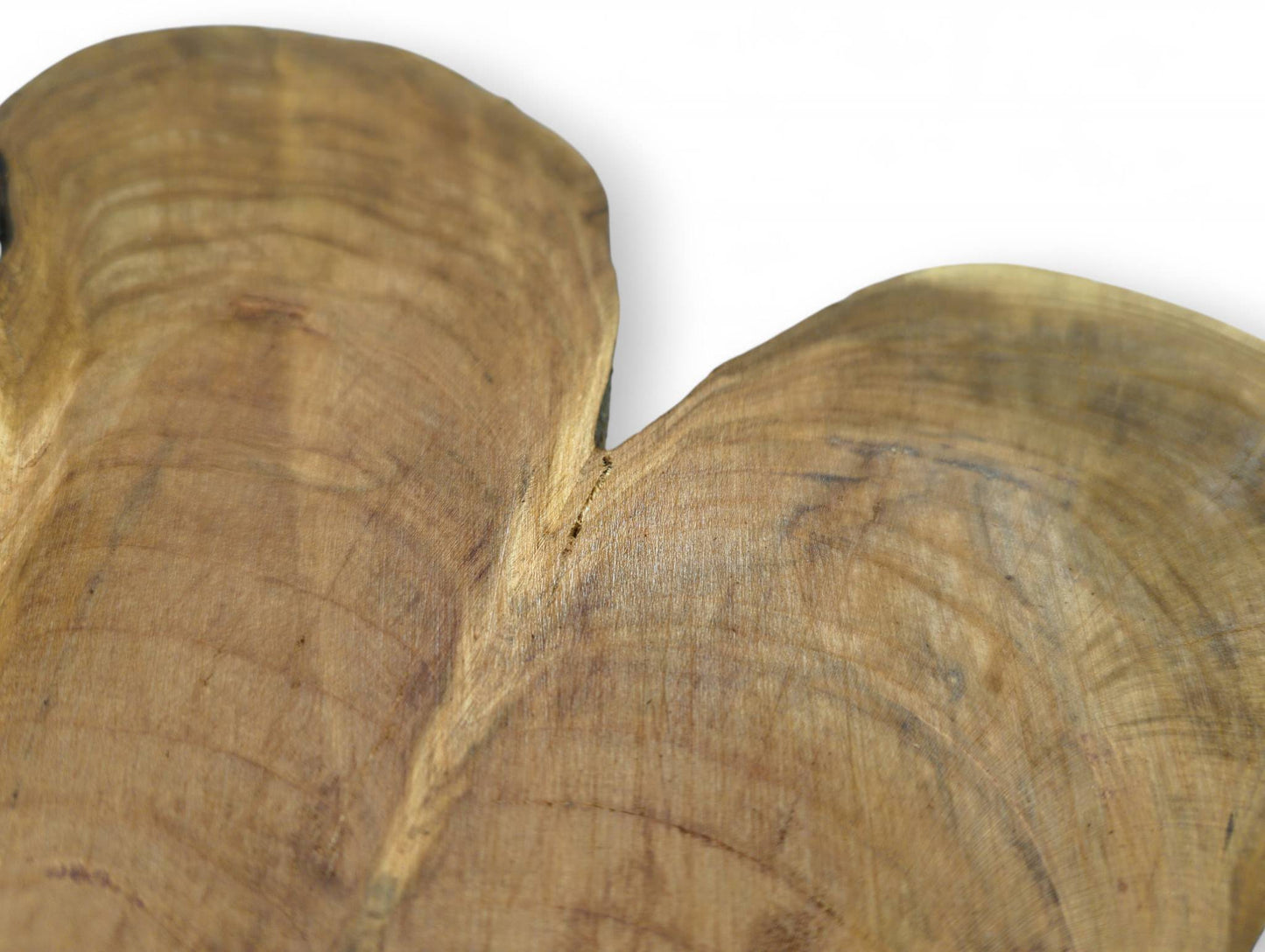 Close-up of a light brown wild cherry wood slice displaying prominent wavy growth rings and a subtle natural crevice.
