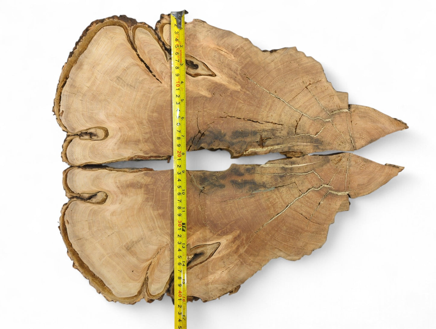 Irregular light brown bookmatched wood slices with natural edges, visible grain, cracks, and a yellow tape.