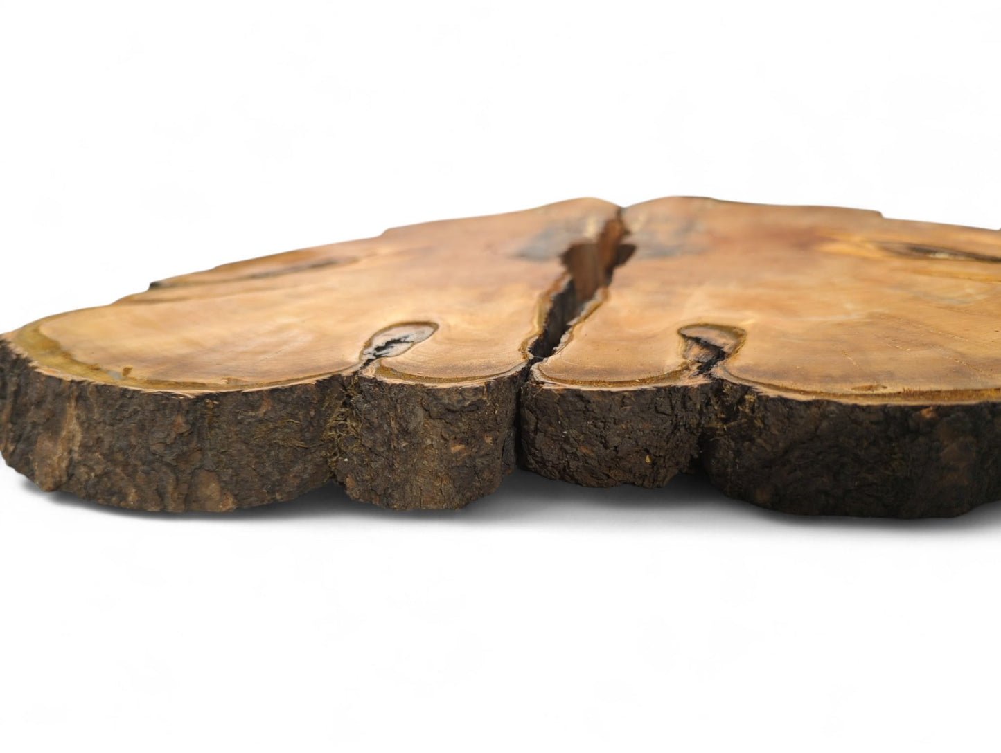 Two irregular bookmatched light brown wood slices with dark, rough live edges and a central gap.