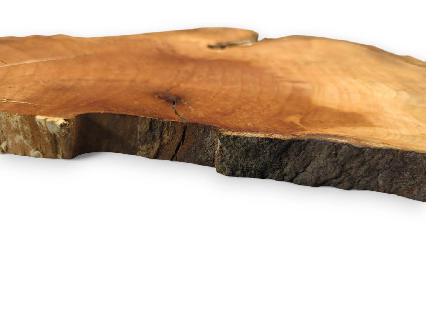 Wild cherry wood slab, irregular, with smooth brown-yellow surface, rough dark live edge, and visible cracks.