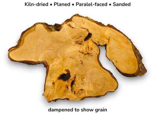 Irregular golden linden wood slab with dark bark edges and text indicating preparation and dampened state.