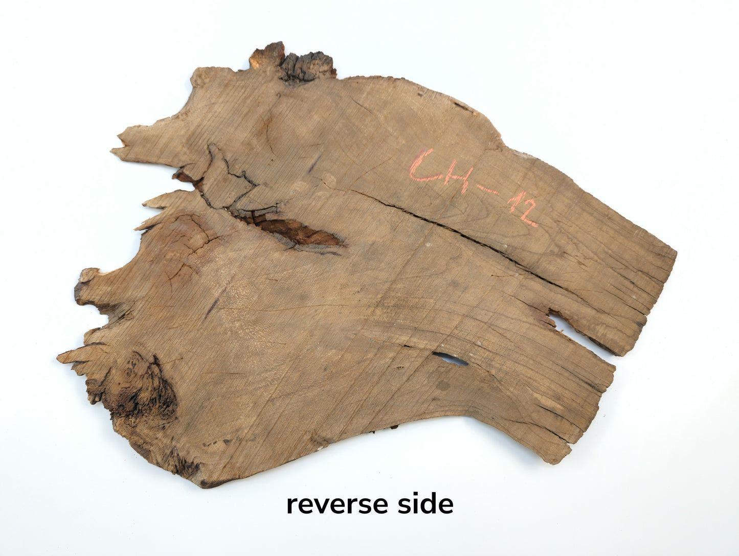 Image showing the reverse side of a raw cherry slab with cracks and handwritten code CH-12.