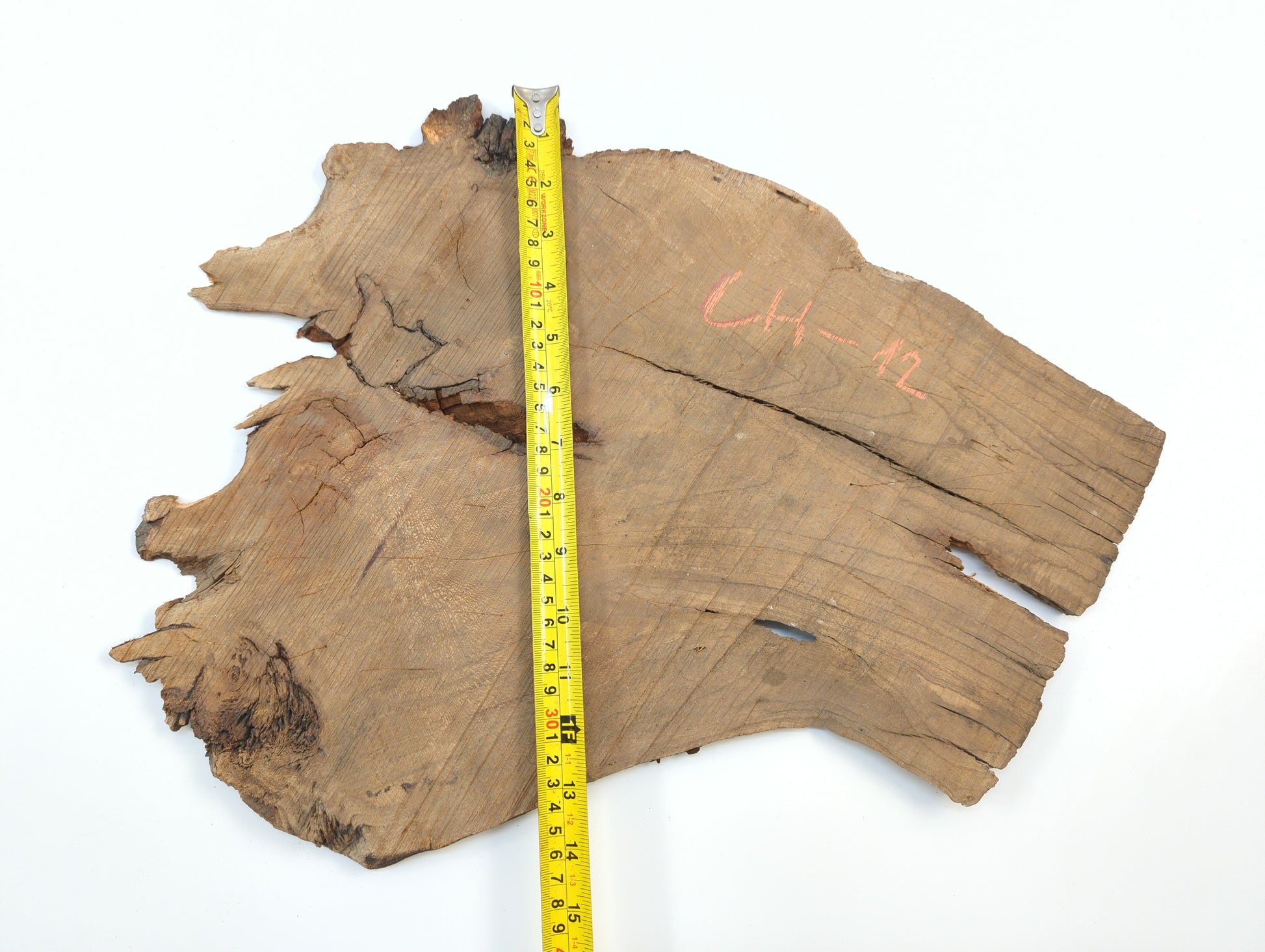 A yellow tape measure indicates the vertical length of a raw cherry wood slab marked CH-12.