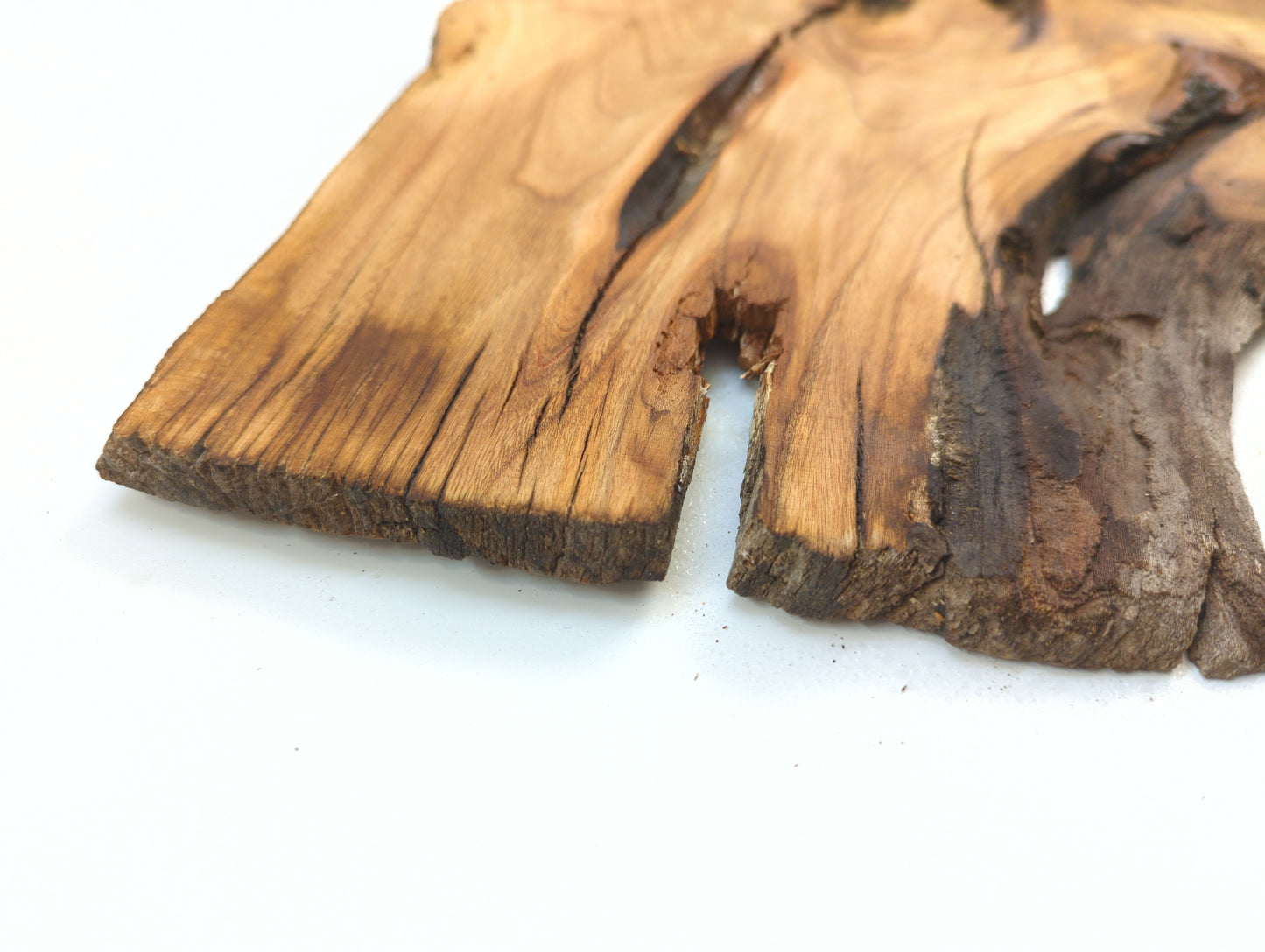 Close-up of a piece of rustic wooden decor on a white background