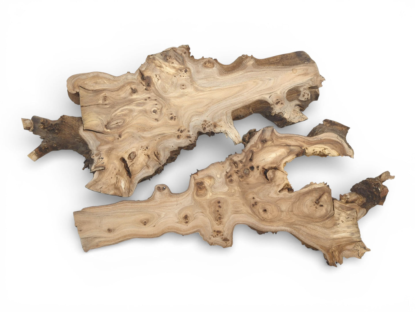 A flat lay of two organically shaped, raw-edged hardwood slabs with swirling grain patterns.