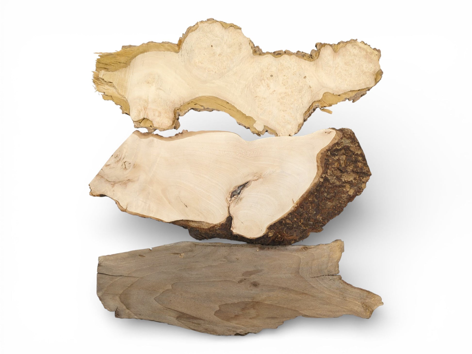 Three wood slabs with natural live edges arranged horizontally to display their unique grain and coloration.