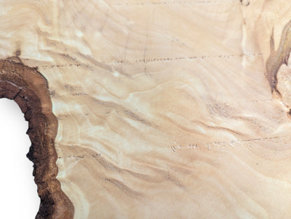 Creamy linden root wood slice with subtle wavy grain patterns and an irregular, dark brown bark edge.