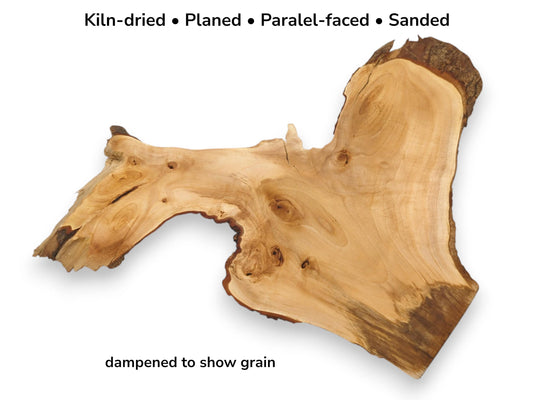 An asymmetrical wood slab shows swirling grain, dark burls, and a rugged, bark-covered live edge.