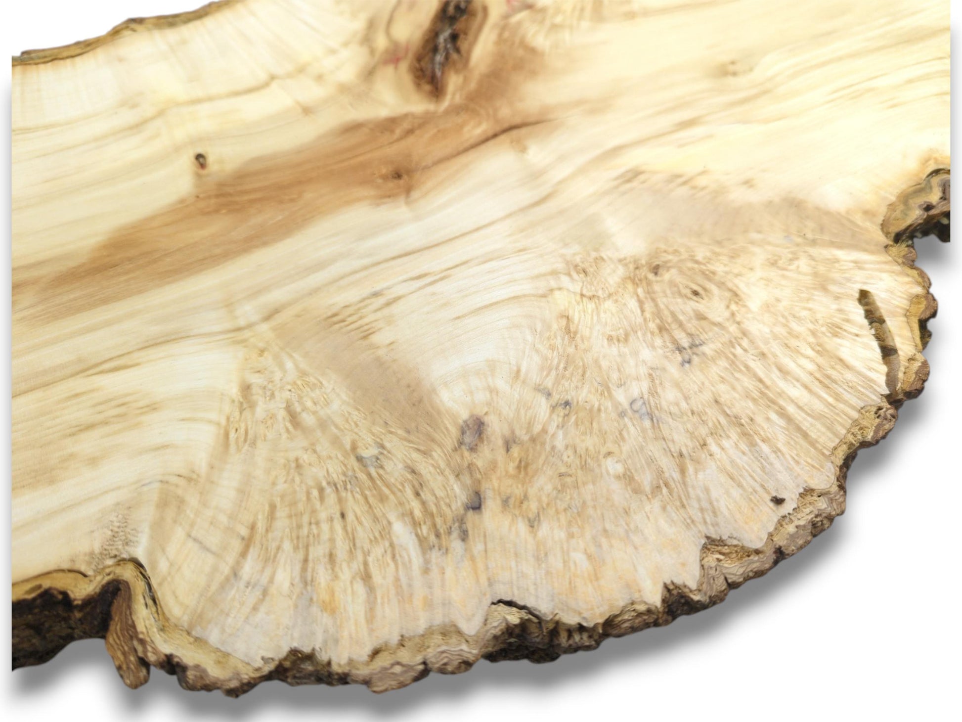 Light-colored lumber shows a flame-like pattern flowing toward the rough, organic perimeter on the right.