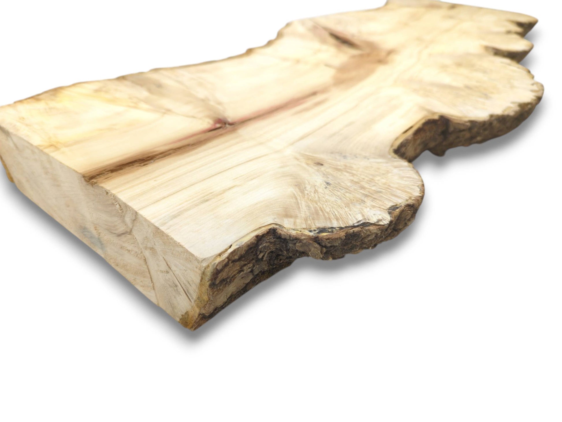 A thick, pale wood cutting displays its sawn end grain and dark, textured live edge.
