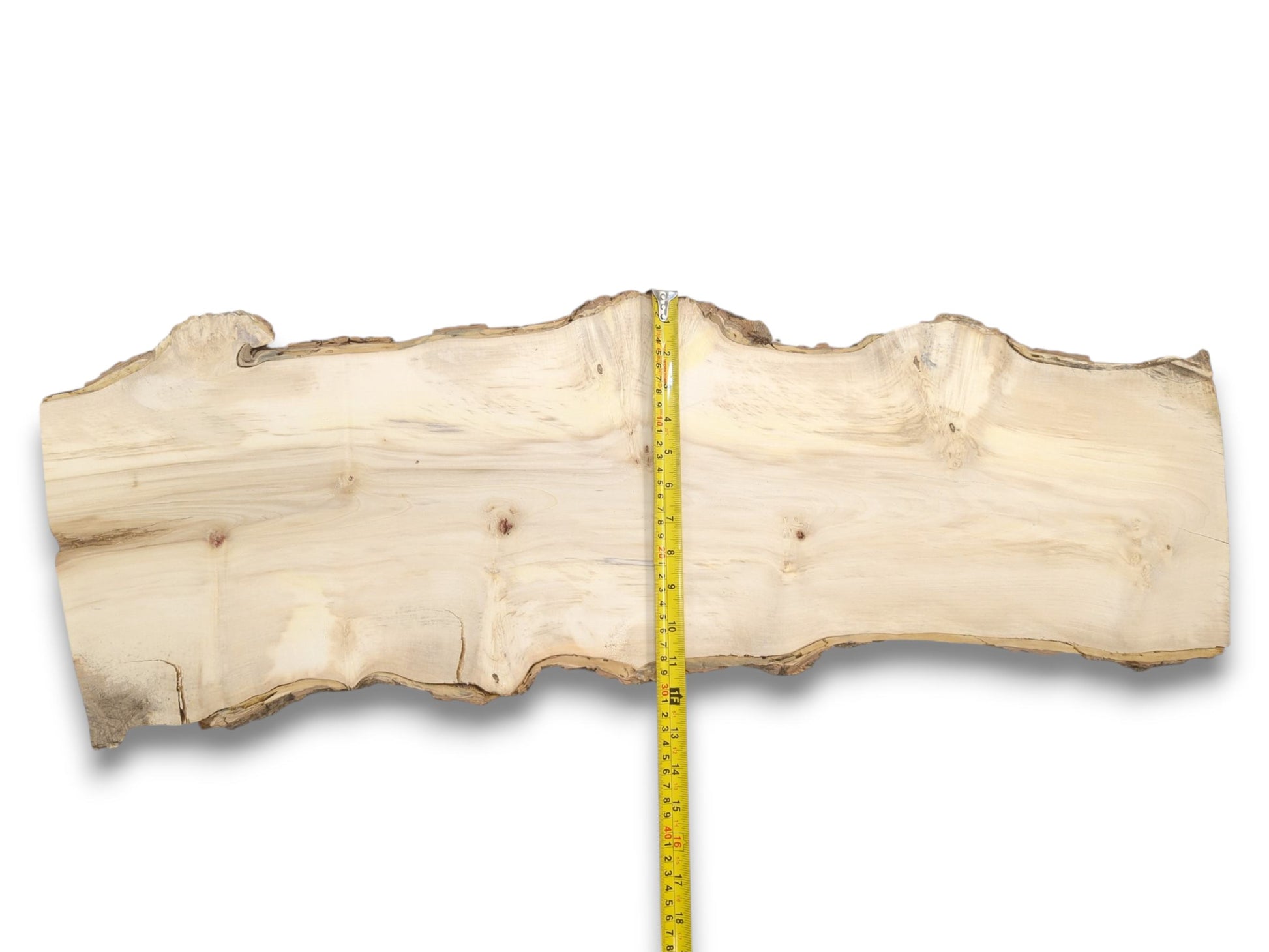 A yellow measuring tape is centered on a pale, live-edge wood slab with faint grain.