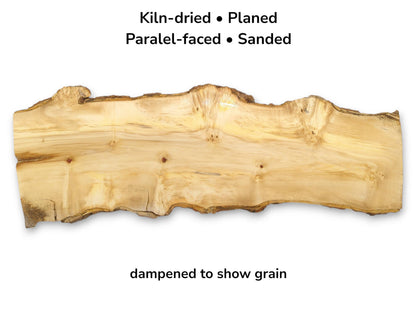 A light-colored timber slab with a swirling grain, several bird's-eye knots, and a natural, wavy edge.