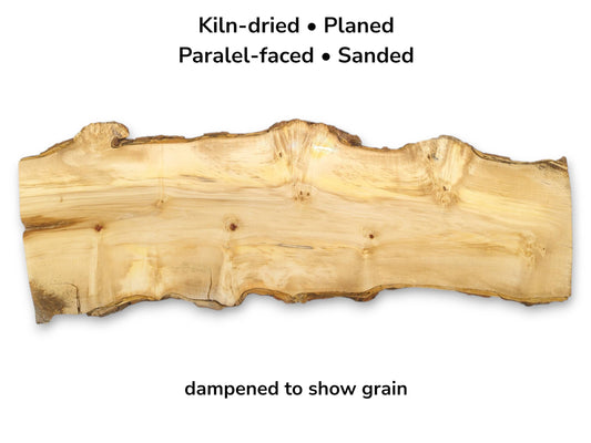 A light-colored timber slab with a swirling grain, several bird's-eye knots, and a natural, wavy edge.