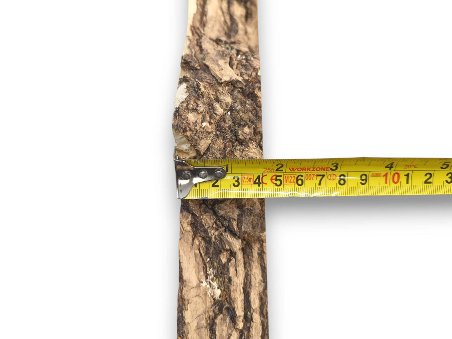 A yellow measuring tape is held across a vertical timber piece with craggy, textured bark.