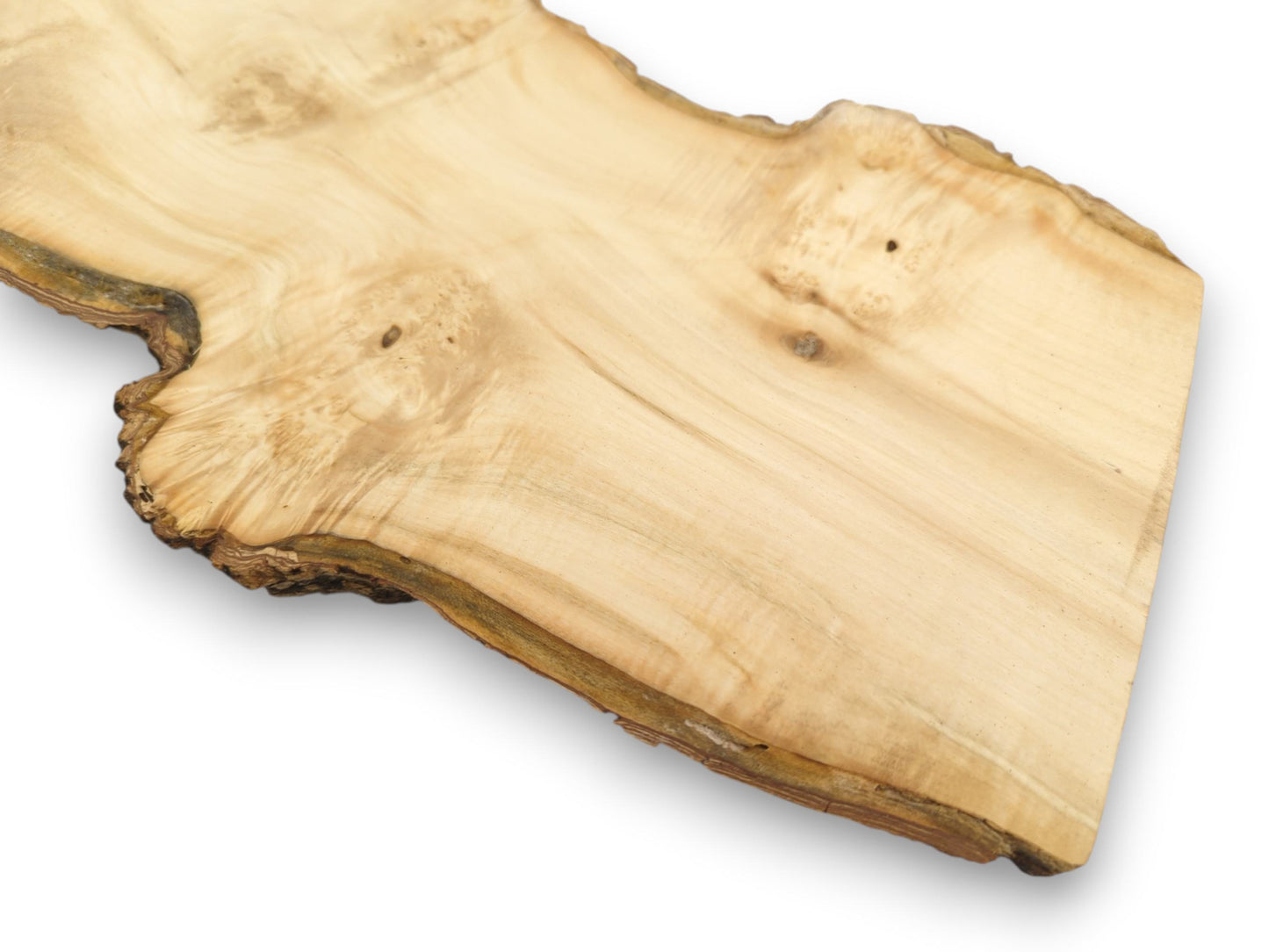 A smooth lumber section displays faint grain waves and a dark, gnarled, bark-lined perimeter.
