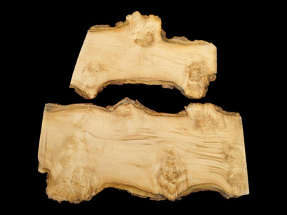 Two pale, planed maple burl pieces display intricate knot clusters and dark, textured live edges.