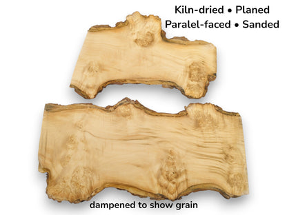 Two irregular maple burl slabs, dampened to show swirling grain and a rough bark edge.