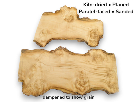 Two irregular maple burl slabs, dampened to show swirling grain and a rough bark edge.