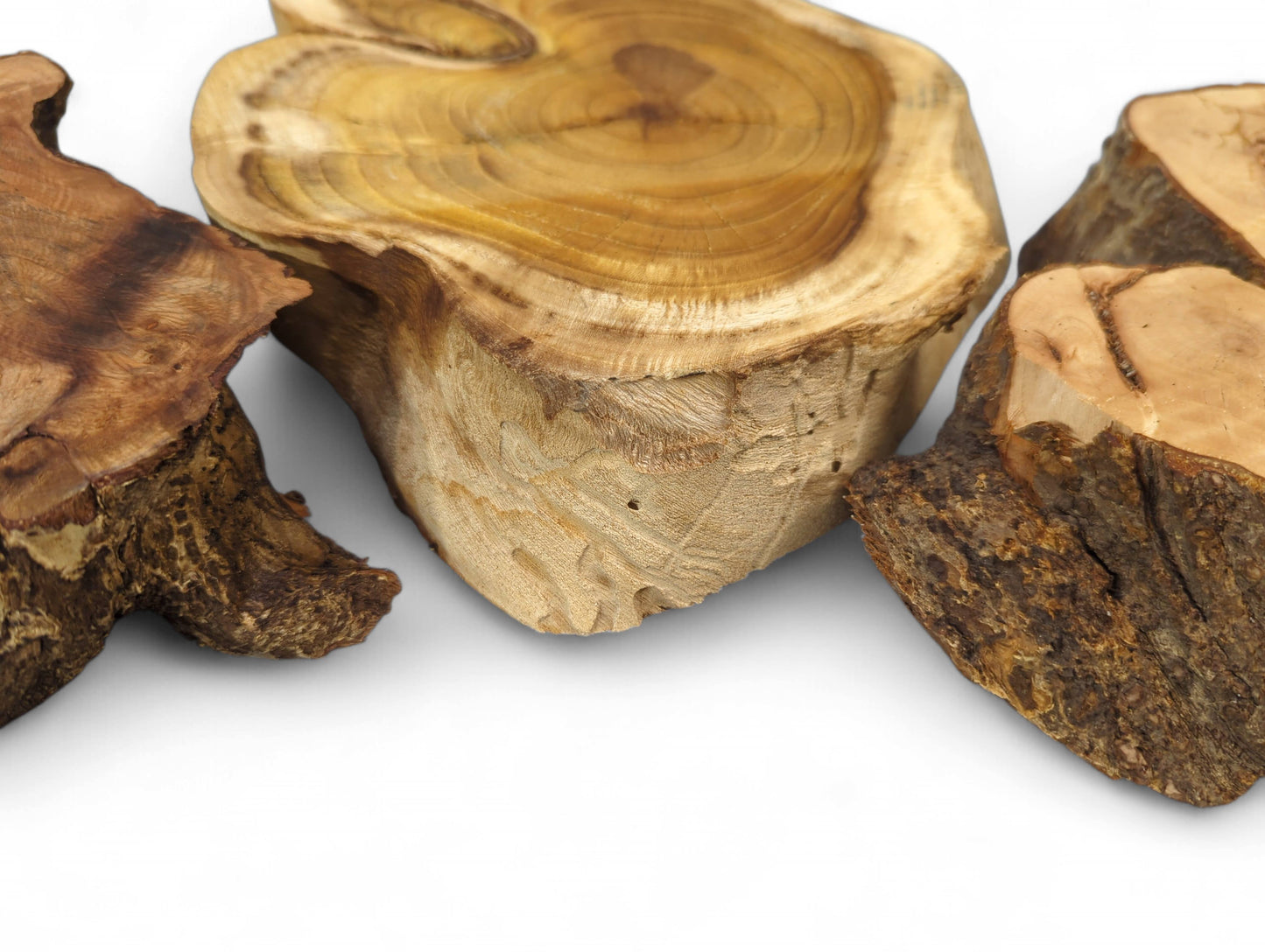 Three raw, irregularly shaped, live edge linden, hazel, mulberry wood slices with sanded tops.