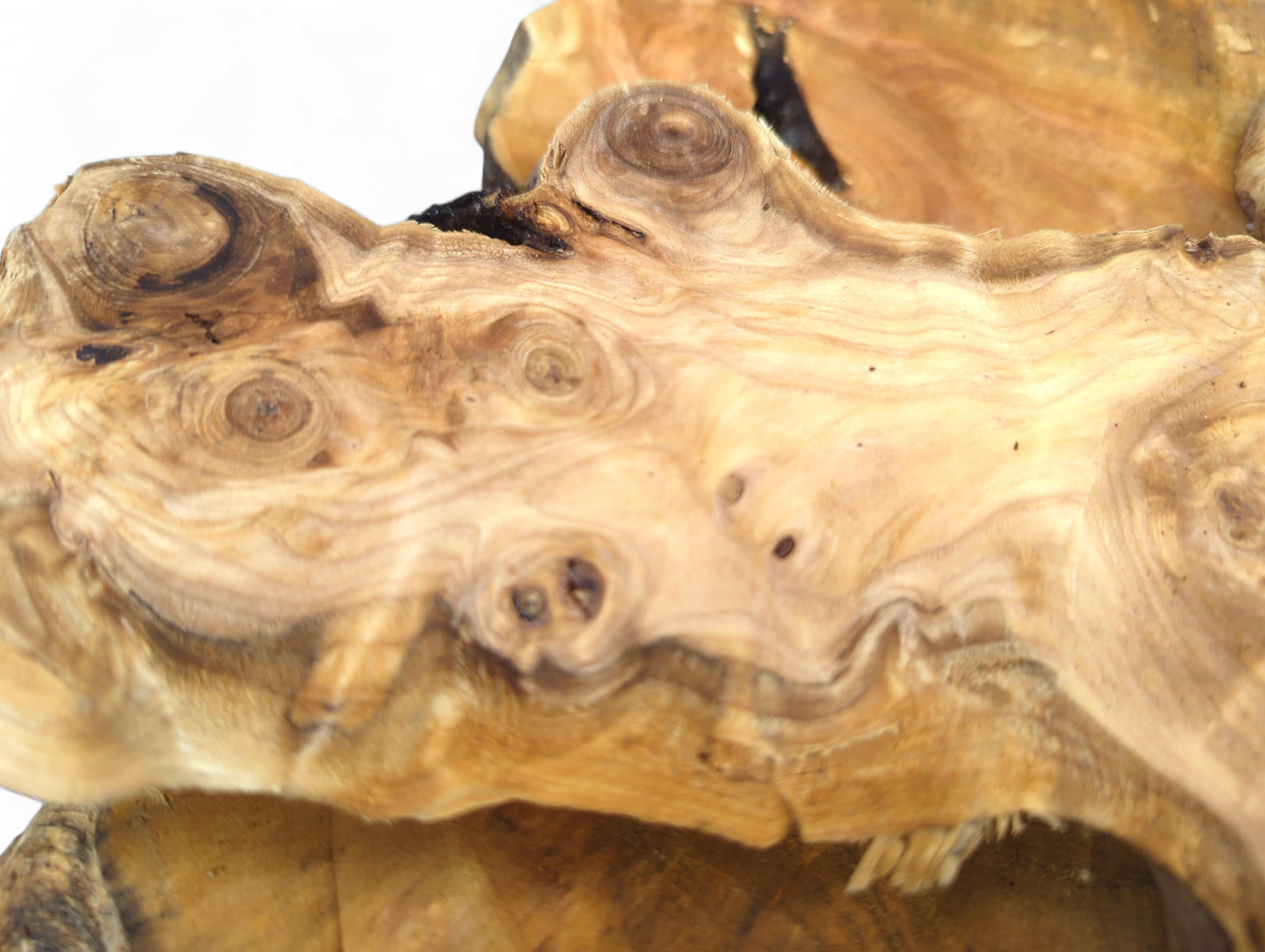 Smooth, irregular light brown wood slice shows prominent knots, swirling grain, and natural live edges.