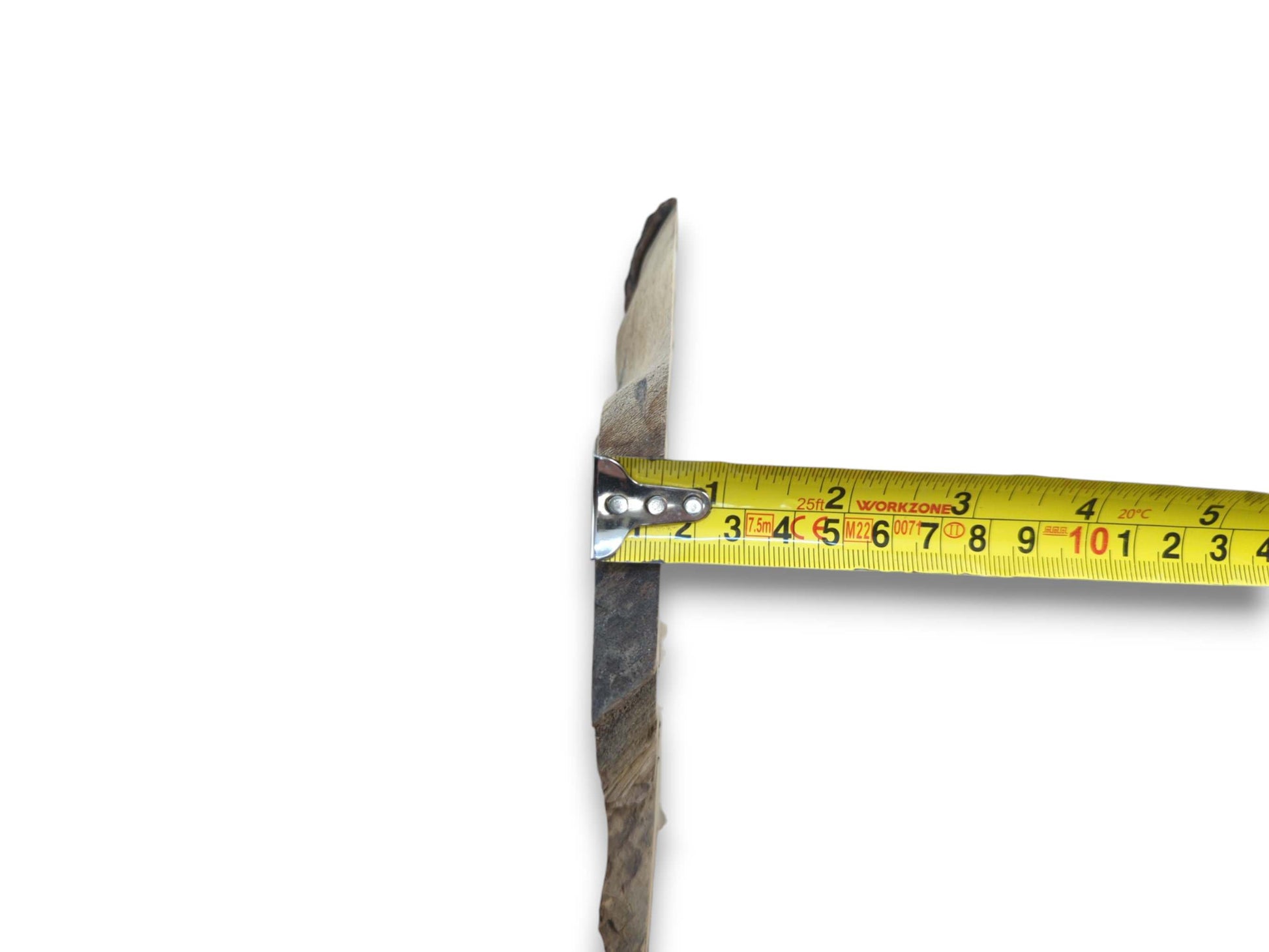 A yellow measuring tape spans across the rough, natural edge of a wood piece.