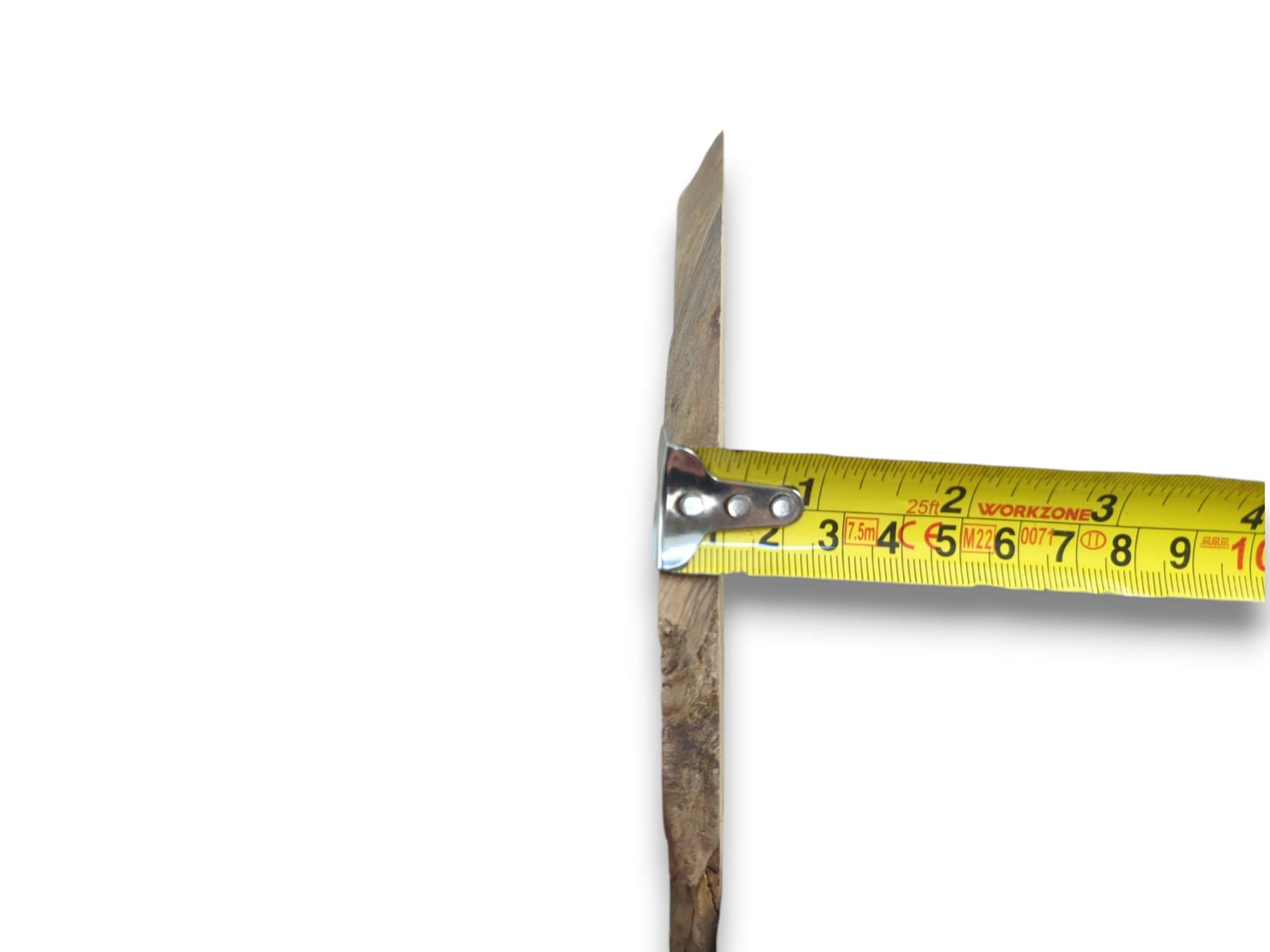 A yellow measuring tape shows the thickness of a rustic wood piece with a natural edge.