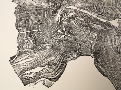 Intricate woodcut monoprint features an irregular dark impression of a tree root with complex grain patterns on cream paper.