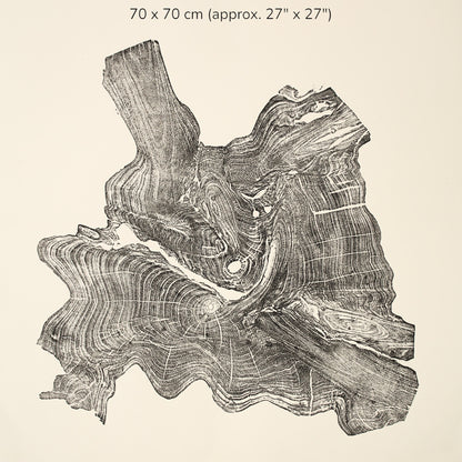 A black ink impression of a gnarled root burl displays chaotic, swirling grain patterns.