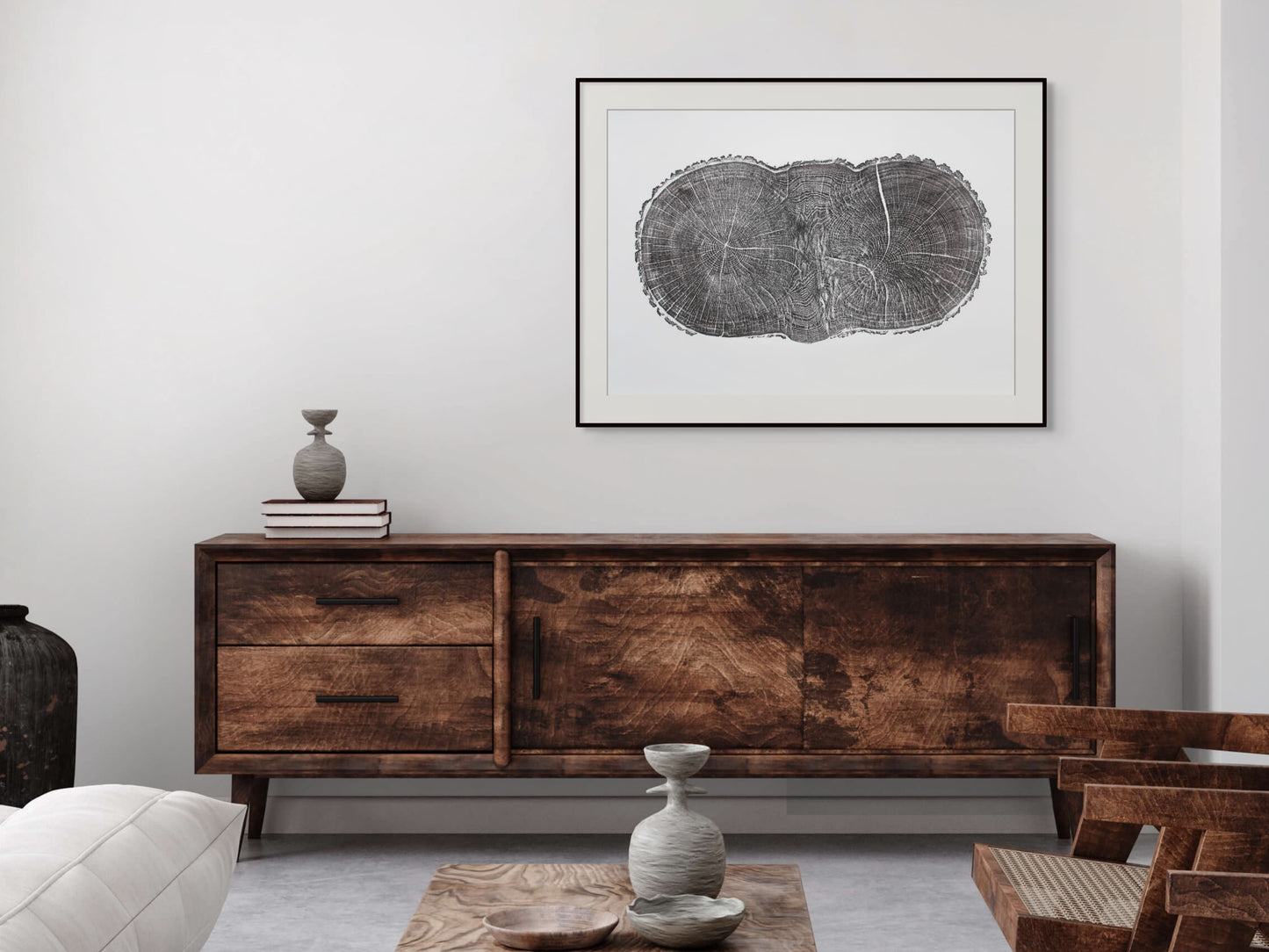 Black-framed print shows an irregular oak cross-section with growth rings and a crack, above a wooden console.