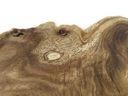 A close, angled shot of a burl wood slice, focusing on its rippling grain and prominent knots.