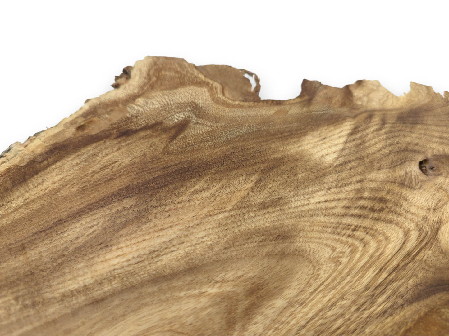 A low-angle view across a timber piece shows its rippling grain and jagged raw perimeter.