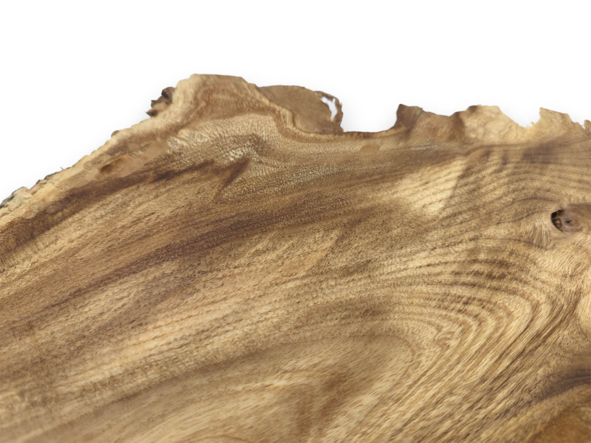 A low-angle view across a timber piece shows its rippling grain and jagged raw perimeter.