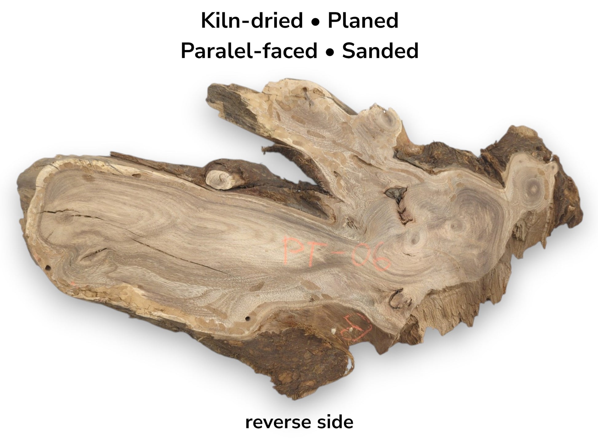 The reverse face of a wood slab reveals wavy grain, small knots, and orange markings.