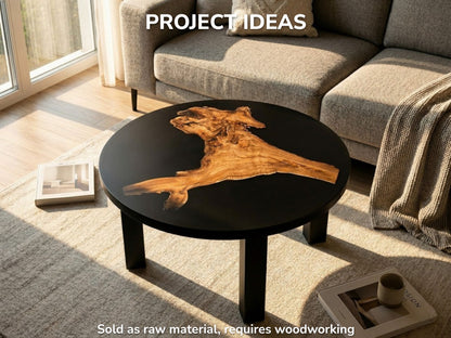 A golden, burled timber piece with an uneven perimeter floats in a black resin tabletop.