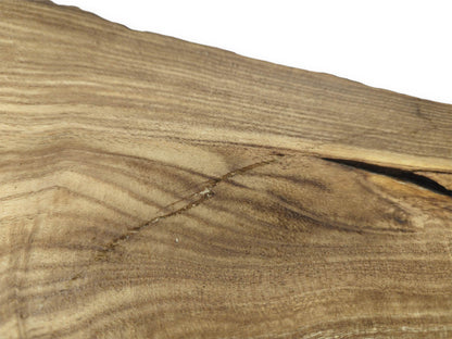 A diagonal scar cuts across the straight grain of a timber slab near a dark fissure.