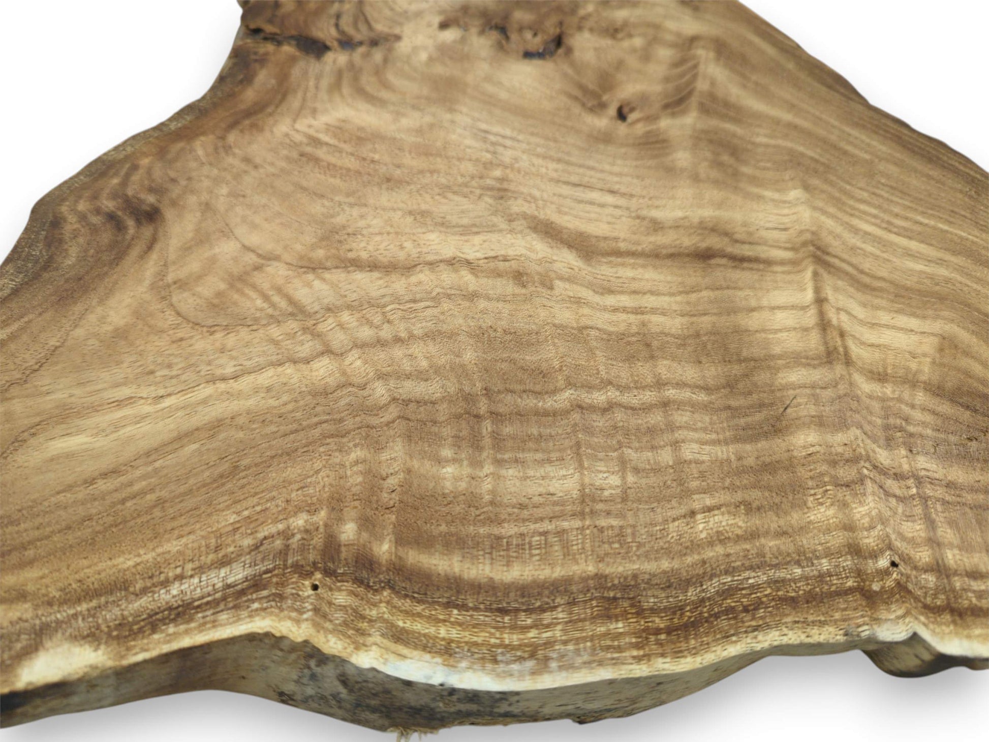 Wavy, contoured grain patterns flow across a wide timber slab with a thick live edge.