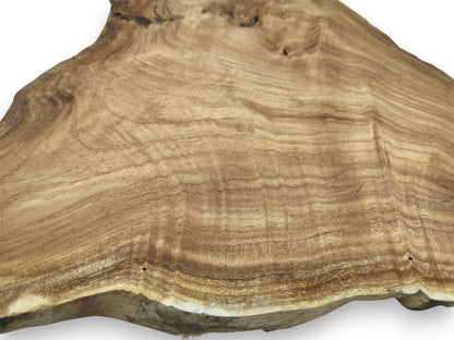 Wavy, contoured grain patterns flow across a wide timber slab with a thick live edge.