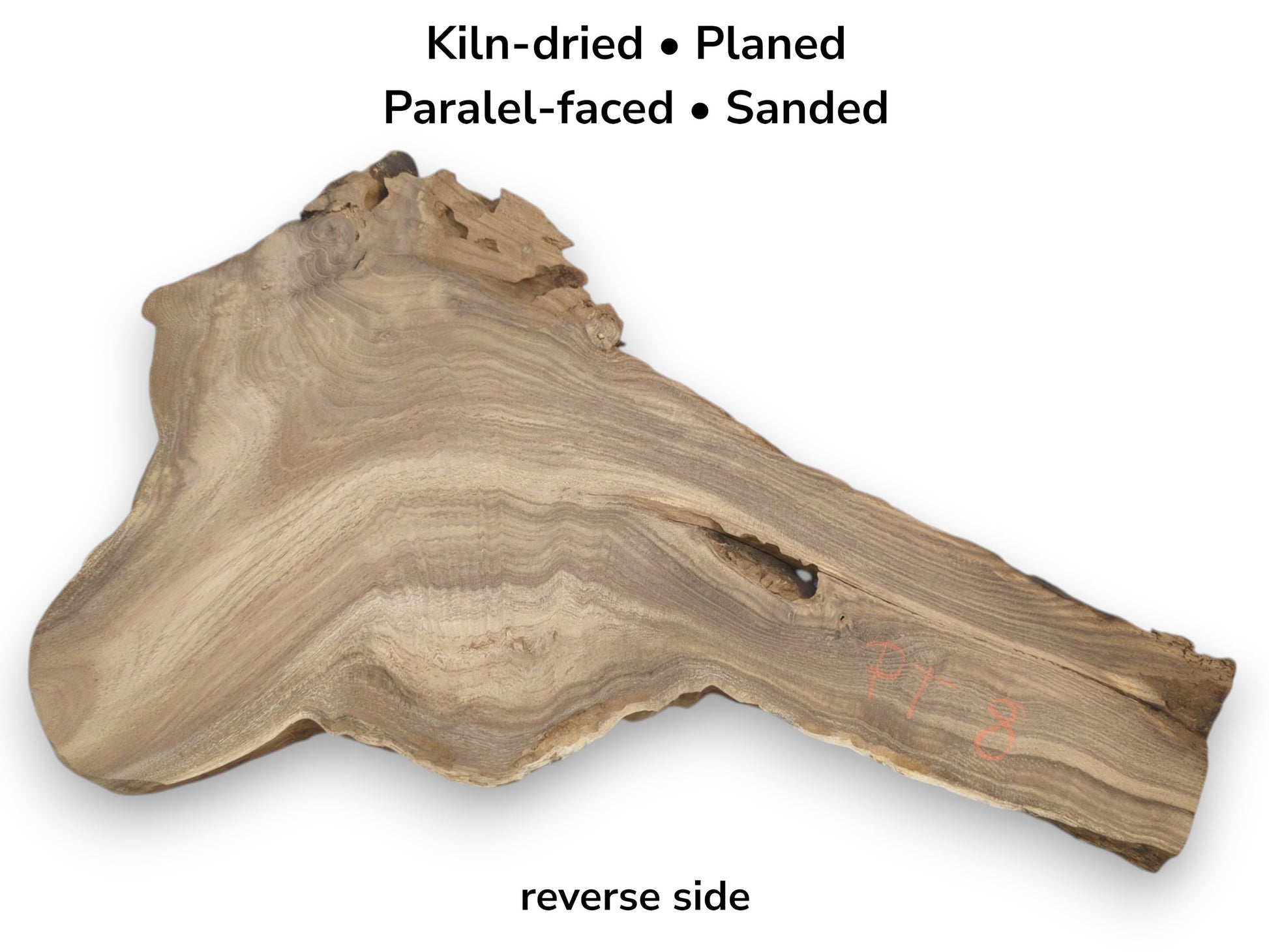 An irregular timber blank shows parallel grain, a jagged top edge, and a single void.