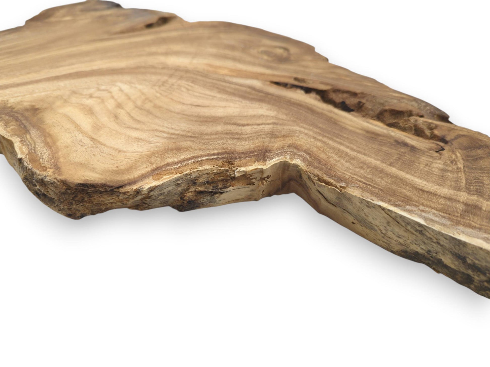A wooden plank seen from a low angle shows undulating grain and a splintery edge.